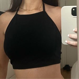 Black high neck crop top.‎